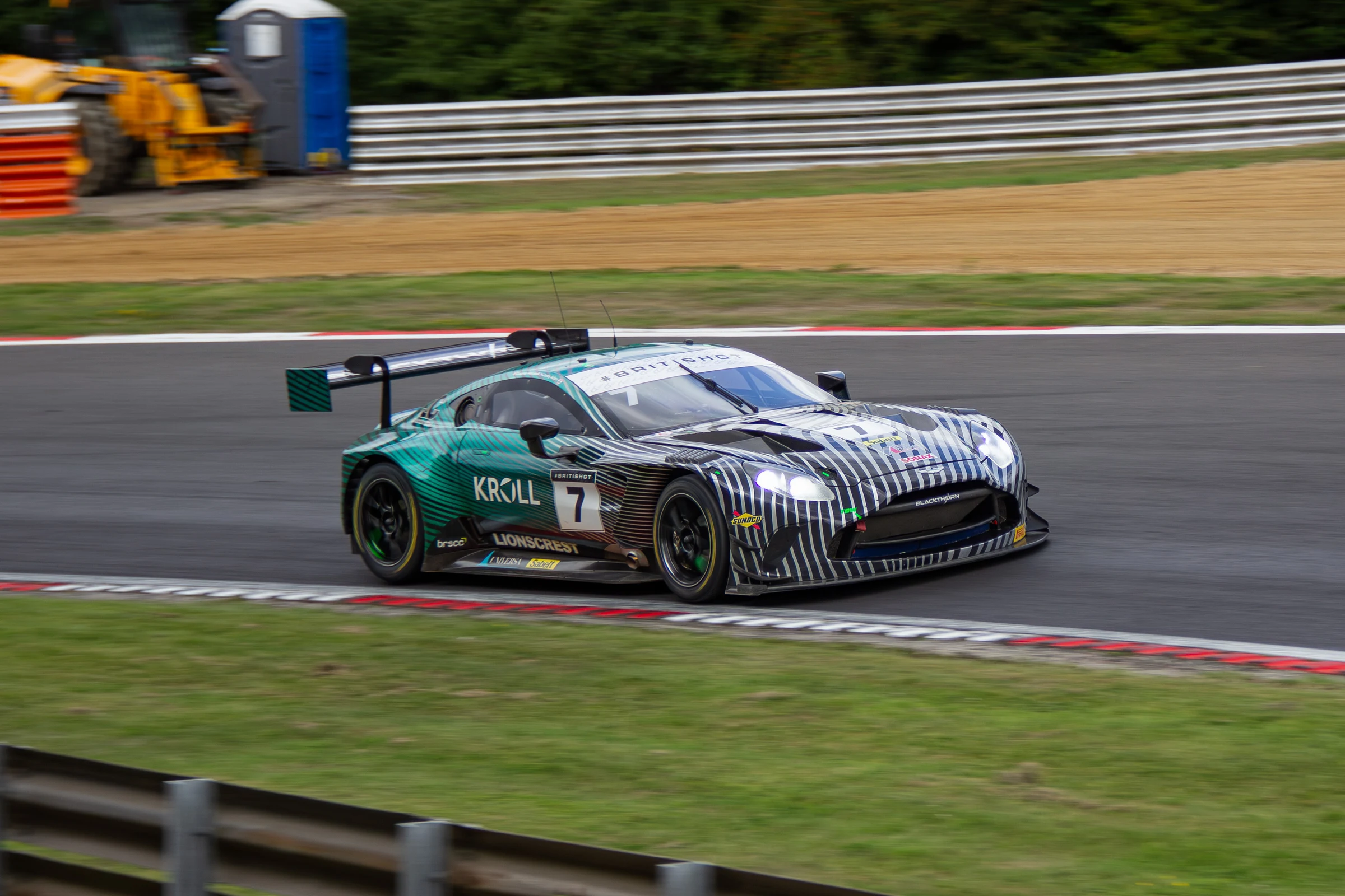 Number 7 Aston Martin turning through Brands Hatch