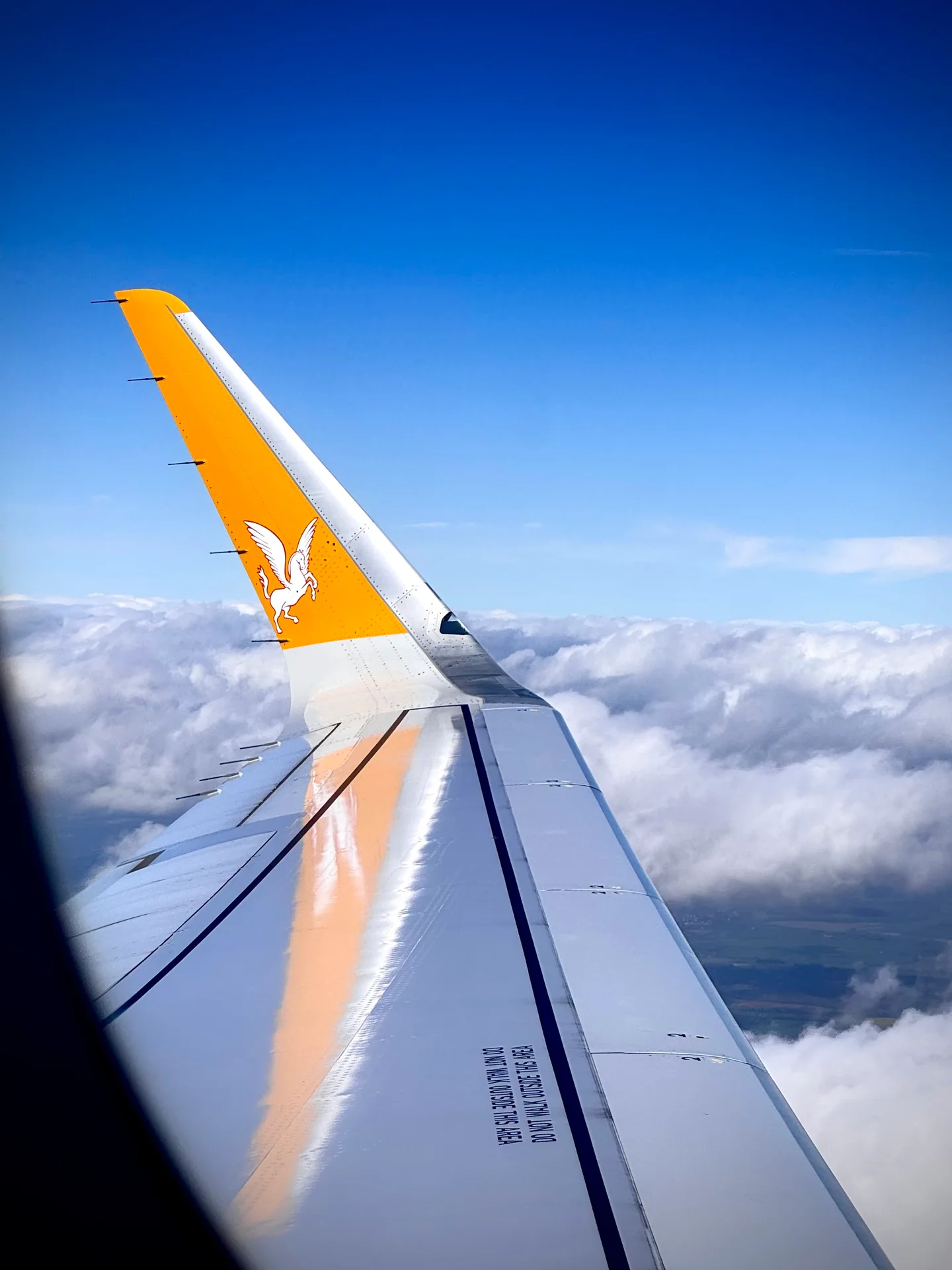 A wingtip above the clouds
